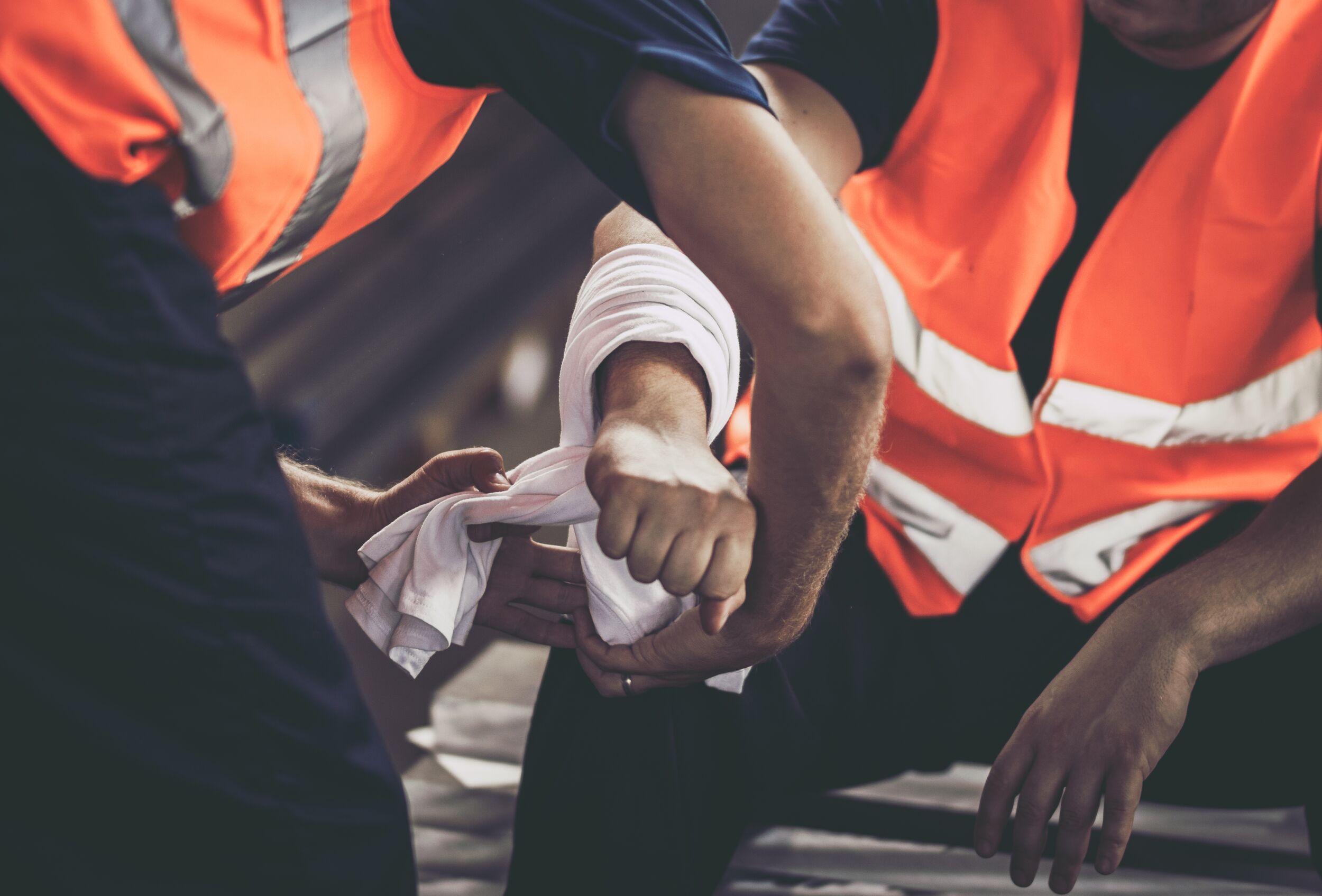 A wounded coworker getting bandaged.