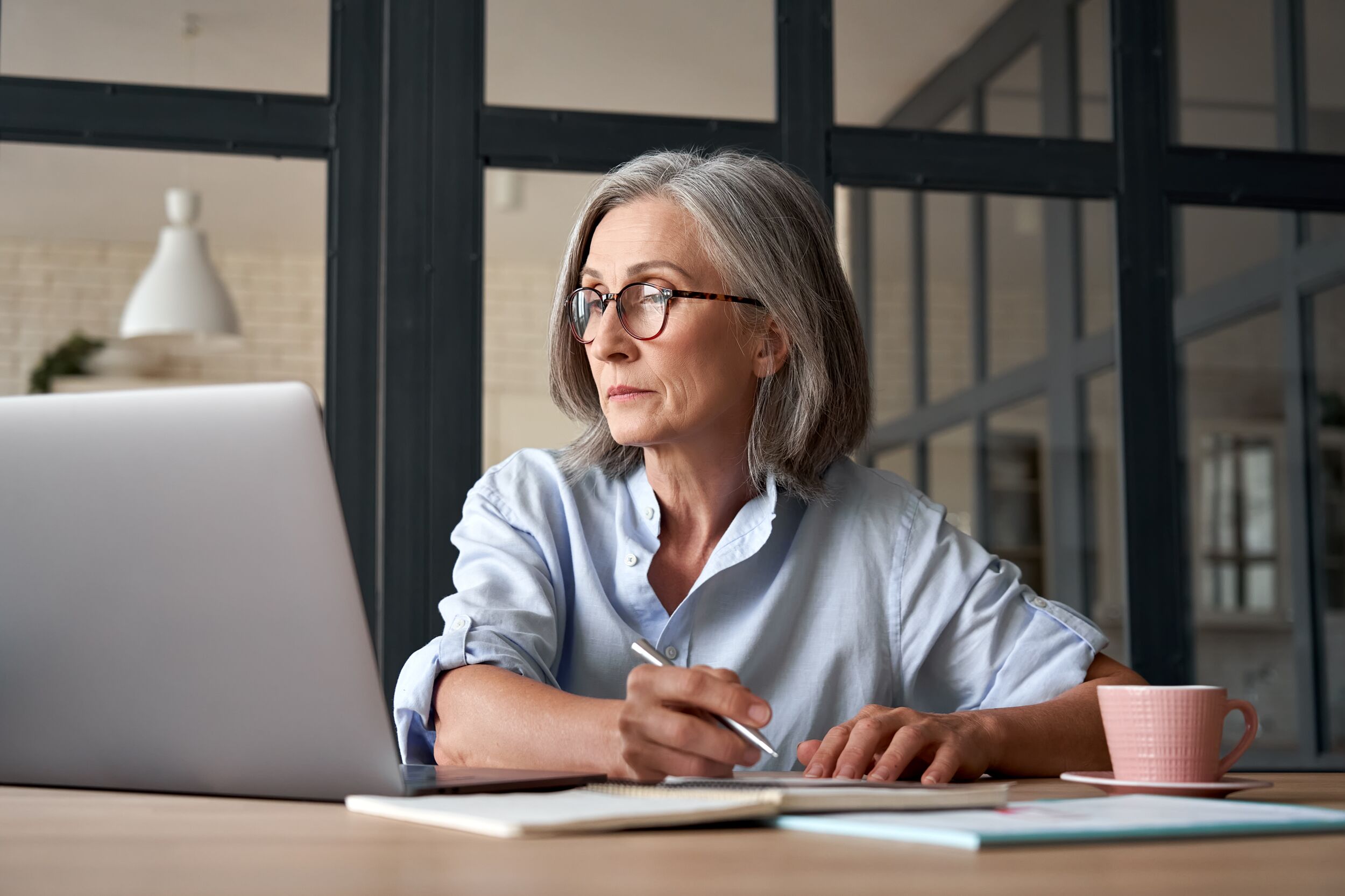 Woman working on a laptop.