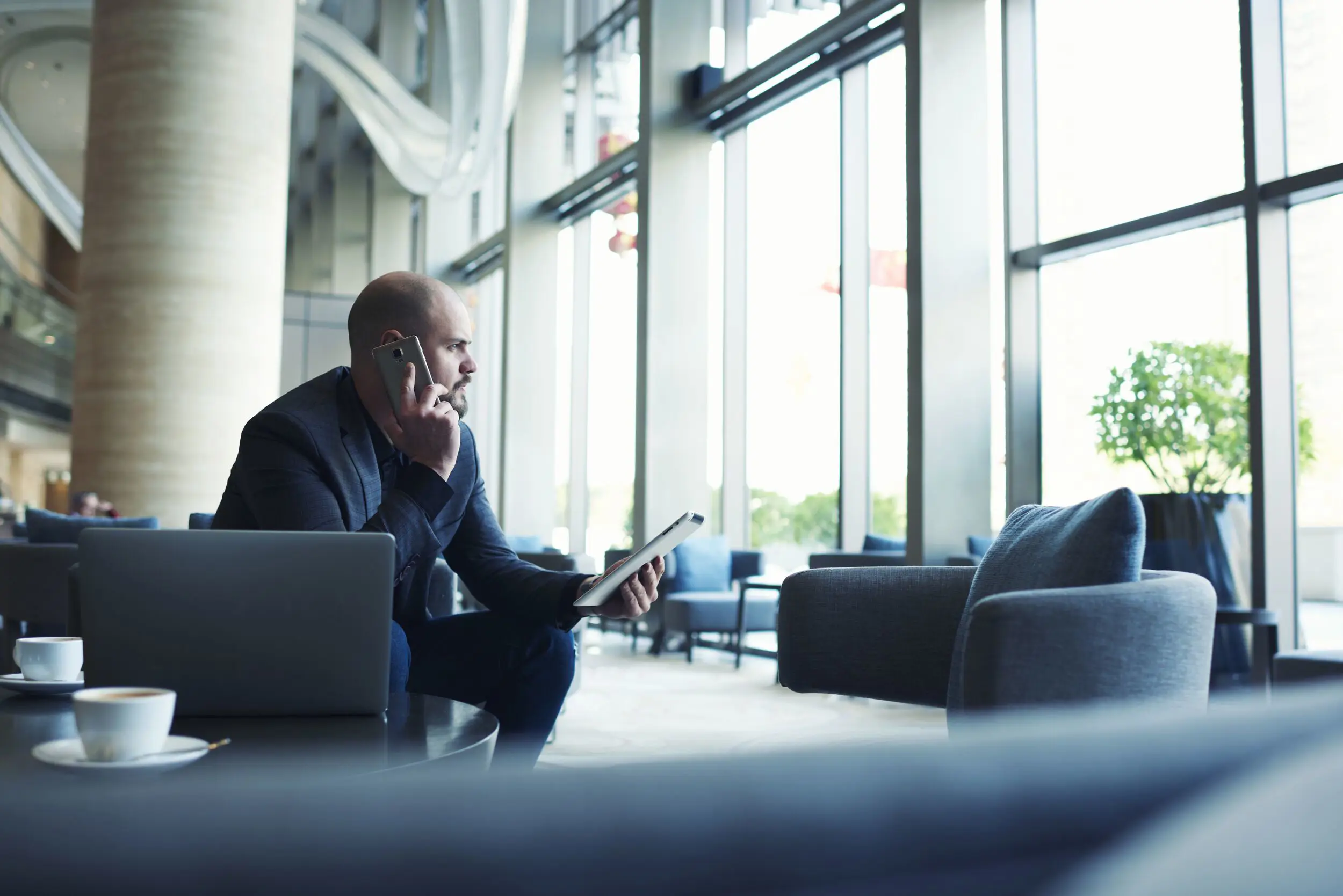 Man on a phone in a lounge.